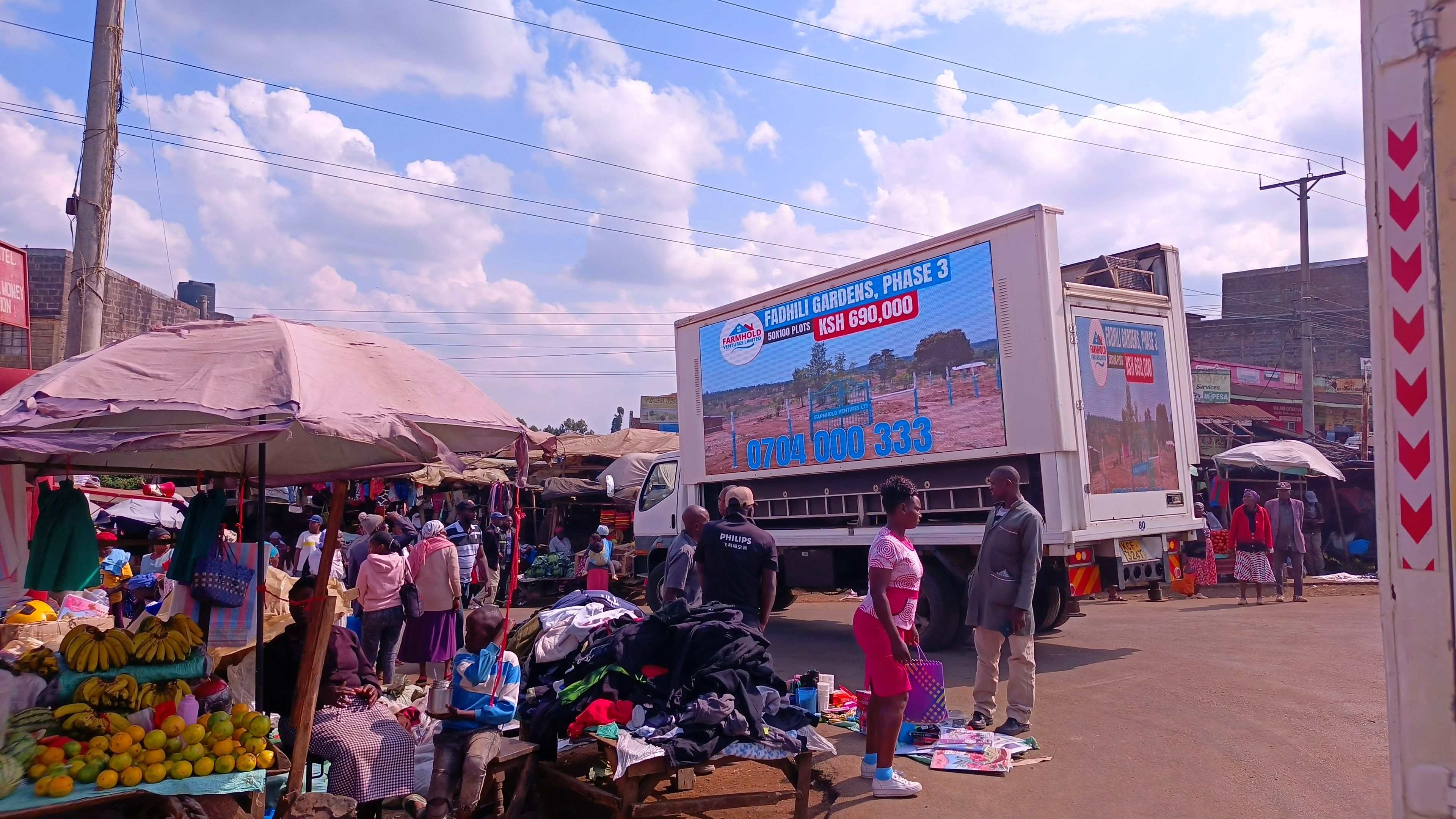 Mobile LED advertising truck at a busy market