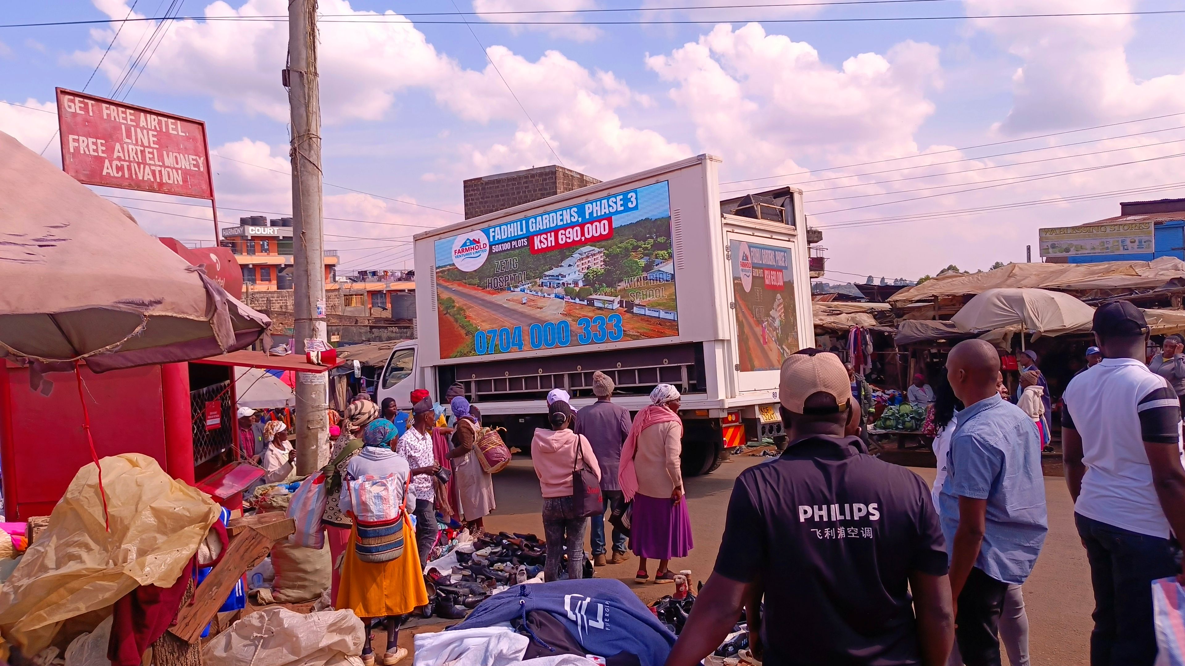 Outdoor advertising truck in a busy market